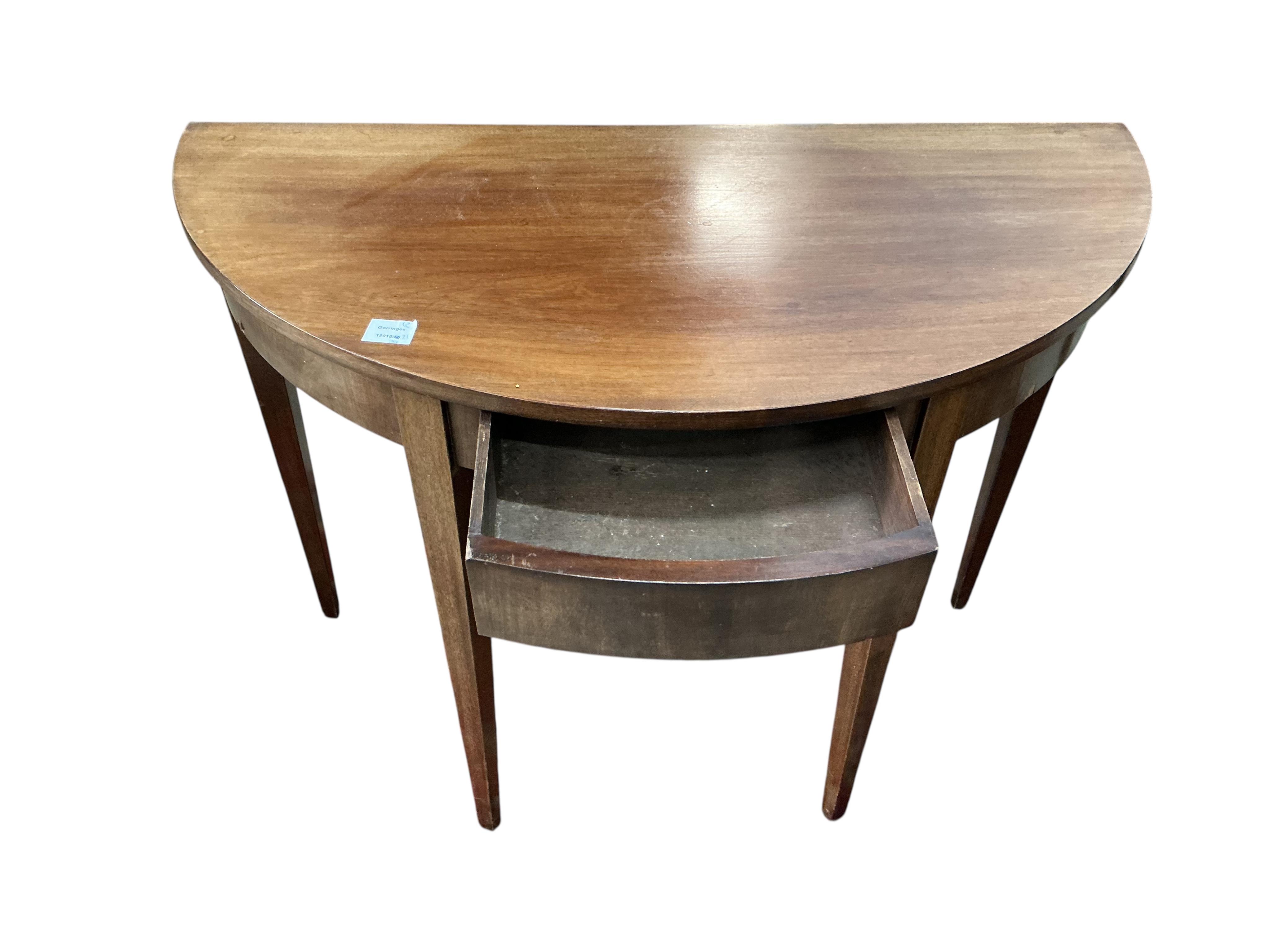 A pair of George III mahogany 'D' shaped tables, each fitted with a single drawer, each width 104cm, depth 50cm, height 76cm together with a pair of George III mahogany dining chairs